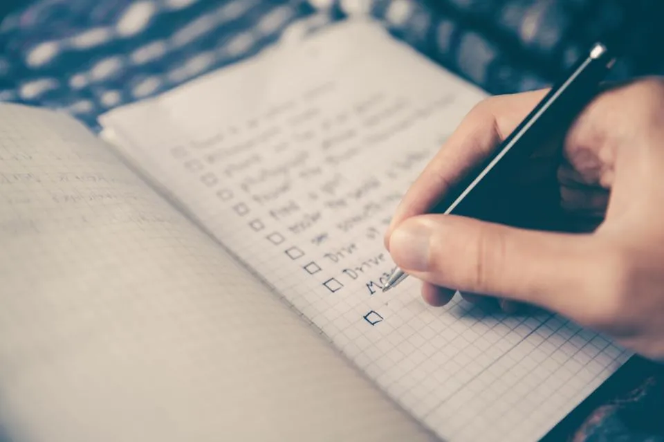 A hand ticking off a checklist